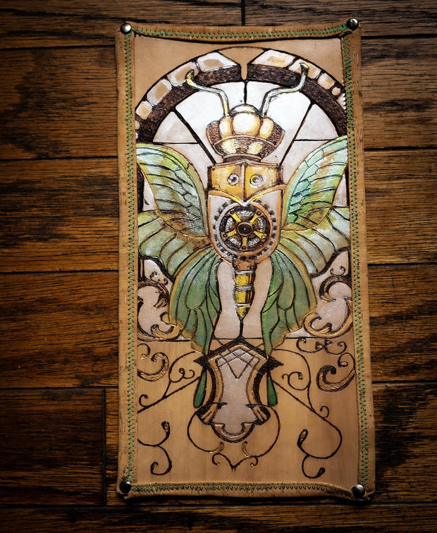 Hand- burned leather desk pad with cork backing full view showing steampunk insect design.