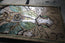 angled view of the steampunk insect edition leather desk mat.