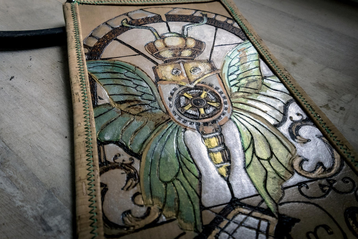 metallic painted detailing on the hand-burned leather table pad.