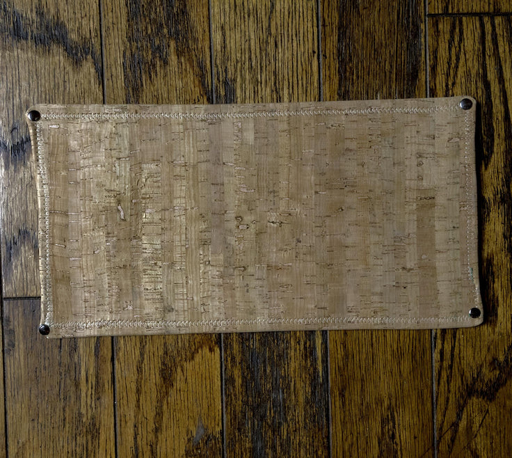 cork backing of the leather table protector pad shown from underneath.